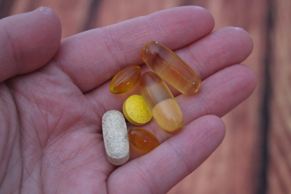 person holding nutrions pills
